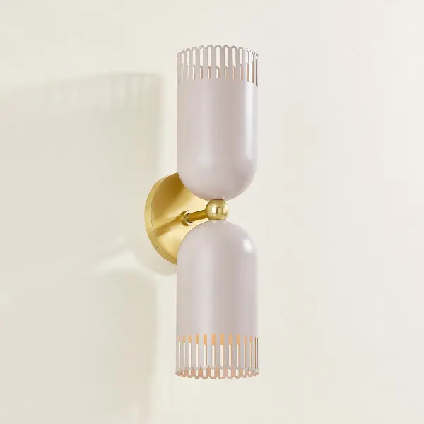 Zoe Feldman's Liba brings sophisticated whimsy to wall lighting with its unique warm neutral shade featuring a subtle pink hue and scalloped edges. The Aged Brass framework adds timeless elegance while the playful design creates an inviting atmosphere. - alternate view