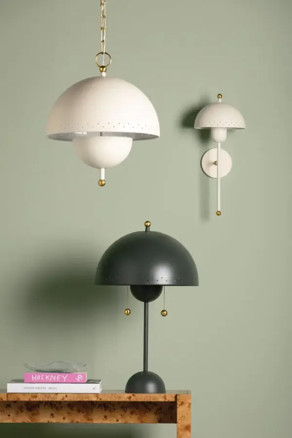 The Jojo Pendant brings midcentury charm with its dome-shaped shade featuring decorative perforations that create beautiful light patterns. Dual bulbs provide optimal illumination while Aged Brass accents add warmth. - alternate view