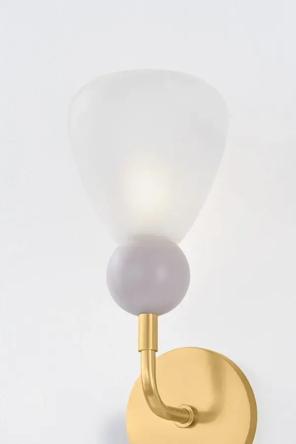 The Doreen Wall Sconce masterfully combines sleek Aged Brass metalwork with whimsical painted peignoir ball details. Its conical etched matte glass shades provide excellent light diffusion while serving as an eye-catching focal point. - alternate view
