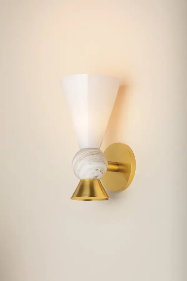 The Mona Wall Sconce combines playful geometry with elevated materials—featuring a striking Calacatta gold marble sphere, opal glass shade, and Aged Brass accents. Part of the exclusive Megan Molten x Mitzi collaboration.