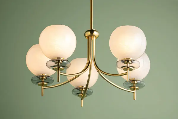 The Alexia Chandelier combines cloud glass orbs with iridescent bubbles in a totemic composition. Aged brass metalwork creates a striking vertical design that's both delicate and bold, perfect for modern interiors. - alternate view