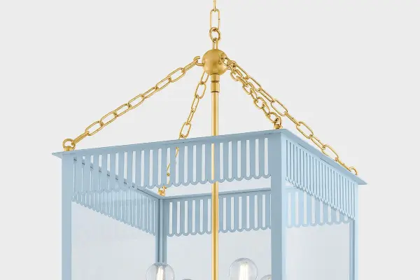 The Rosalie Lantern beautifully bridges traditional and contemporary design with its scalloped slatted details and fresh color palette. The Aged Brass finish paired with Soft Arctic Blue creates a sophisticated yet playful aesthetic perfect for modern traditional interiors. - alternate view