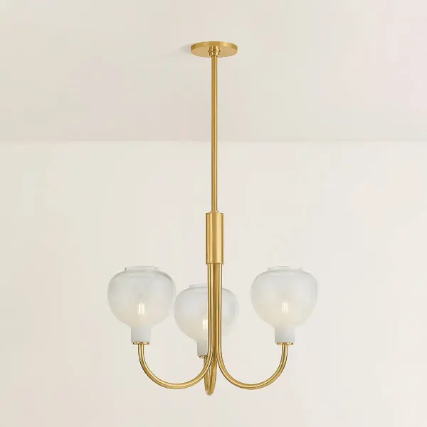 The Estelle Chandelier beautifully bridges transitional and modern design with its graceful J-arm silhouette and distinctive Sfumato glass shades. The warm Aged Brass finish paired with cloudy glass creates an inviting ambiance perfect for dining spaces and entryways. - alternate view