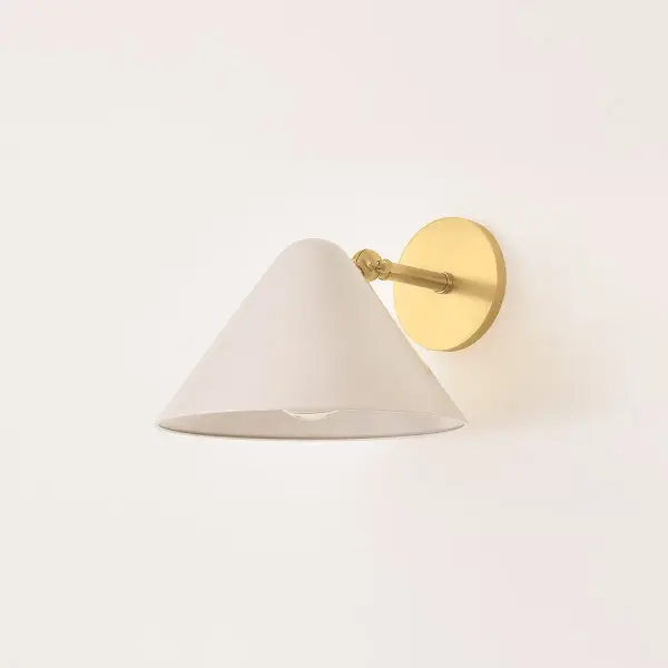 The Sonja Wall Sconce blends mid-century charm with modern simplicity through its rounded geometric form and soft bisque shade. Perfect for creating ambient lighting in intimate spaces with its warm aged brass finish. - alternate view