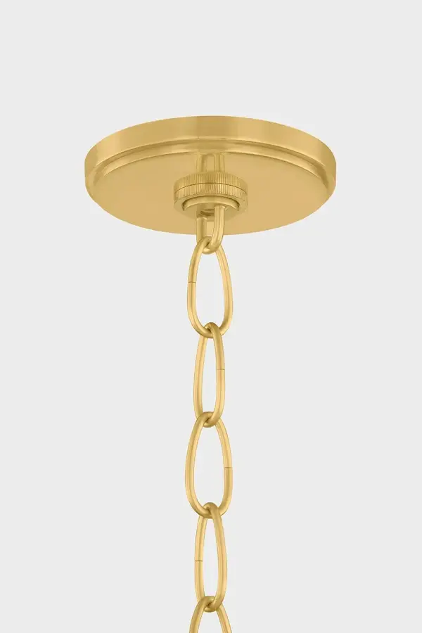 The Della pendant combines organic beauty with refined craftsmanship. Its clear glass shade reveals intricate floral metalwork, while the curved form and botanical cut-outs create visual interest from every angle. Perfect for adding warmth to kitchens and dining spaces. - alternate view