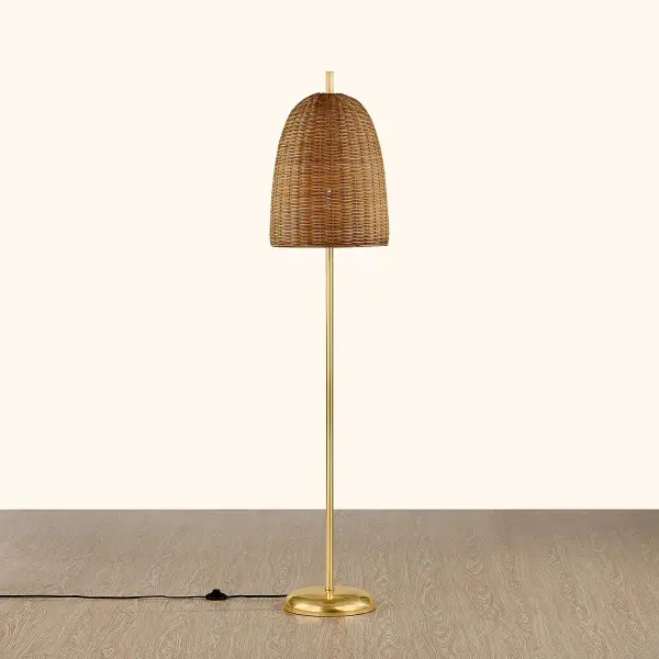 The Beatrice Floor Lamp combines traditional basketry craftsmanship with modern sophistication. Its oversized woven wicker shade creates soft, ambient lighting while the Aged Brass base adds refined elegance. - alternate view