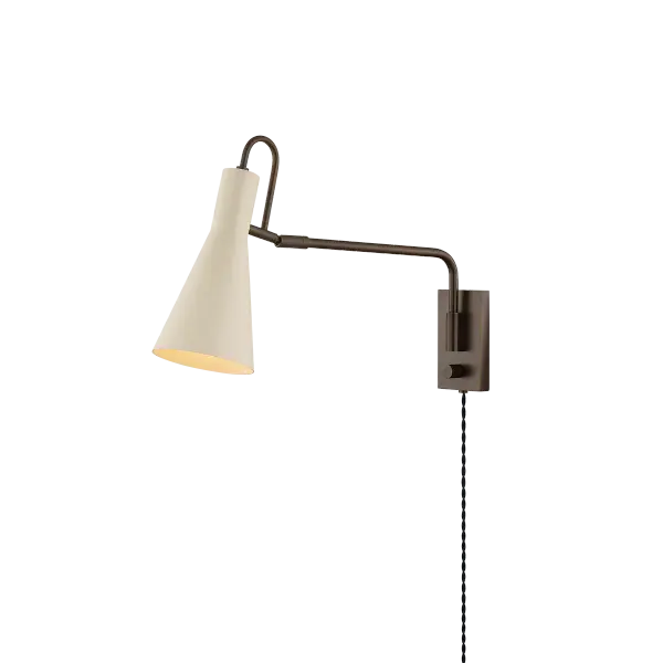 The Yvette plug-in sconce reimagines vintage design with modern simplicity. Its adjustable arc-shaped handle and creamy Soft Bisque finish provide directional lighting perfect for task-focused spaces.