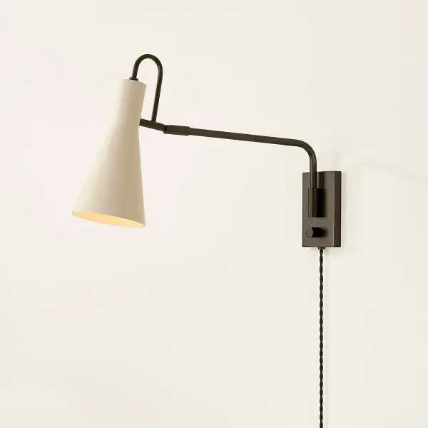 The Yvette plug-in sconce reimagines vintage design with modern simplicity. Its adjustable arc-shaped handle and creamy Soft Bisque finish provide directional lighting perfect for task-focused spaces. - alternate view