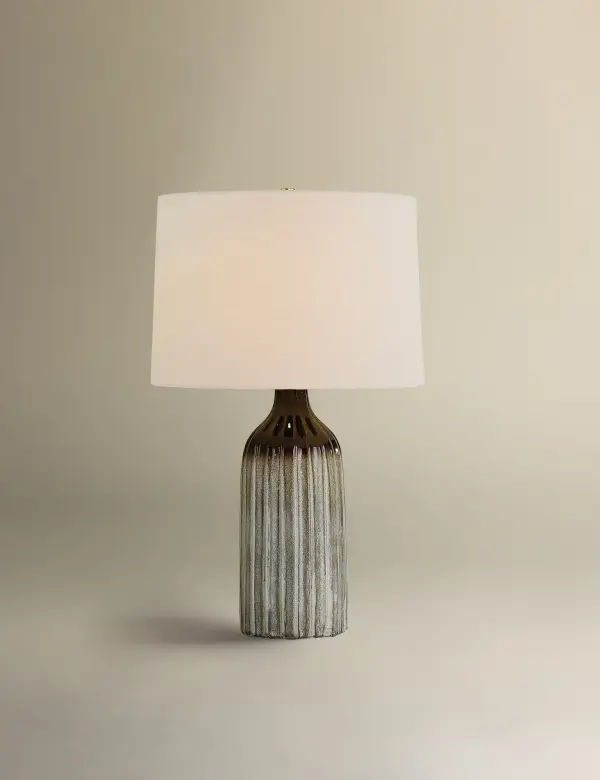 The Raisa table lamp showcases stunning reactive glaze artistry with mocha-to-white ombre tones cascading over a fluted ceramic base. Each piece is unique with hand-applied glazing that creates depth and dimension. - alternate view