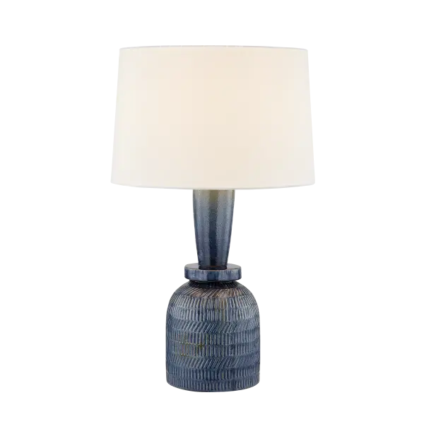 The Russo Table Lamp combines artistic craftsmanship with everyday functionality. Its stacked ceramic base features a distinctive ombre glaze and etched texture, while the oversized white linen drum shade provides balanced proportions and soft ambient lighting.