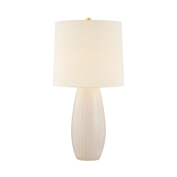 The Shavani brings sophisticated warmth to any space with its elongated ceramic base featuring unique vertical whipstitch-inspired texture. The creamy Honeydew glaze paired with aged brass hardware and generous linen shade creates an earthy yet refined aesthetic perfect for transitional interiors.
