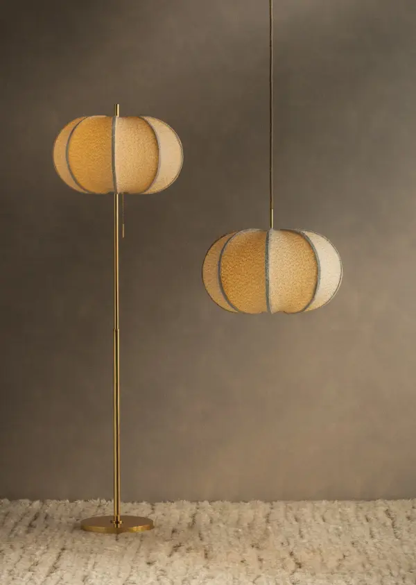 A feminine take on a voluminous, balloon-shade silhouette, the Alexandra family brings an extra dose of cozy comfort to contemporary interiors. As a pendant in two sizes and a floor lamp, it exemplifies designer Hilary Matt's philosophy of elevating simple forms with distinctive materials. Constructed of stretched ivory boucle fabric, the faceted shades nod to mid-century minimalism with a tactile upgrade. Sleek Aged Brass stems complete each playful, yet sophisticated piece. Part of our Hilary Matt x Mitzi Tastemakers collection. Collection: Alexandra Designer: Hilary Matt Finish: Aged Brass Glass: Textured Linen Width: 20.00" Height: 64.00" Weight: 16.76 lb Number of Bulbs: 1 Maximum Wattage: 15.00 W Bulb Type: A19 Bulb Base: E26 Medium Voltage: 120.00 V Material: Steel Country of Origin: VN Safety Listing: UL/cUL Safety Rating: Dry Switch: ON/OFF PULL CHAIN Manufacturer Warranty: 1 Year Limited Manufacturer Spec Sheet Instructions - alternate view