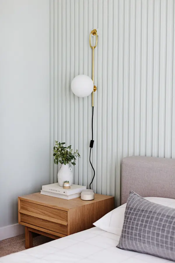 The Gina Plug-In Sconce combines classic elegance with modern convenience. Its aged gold brass finish and glass globe shade create warm, ambient lighting without hardwiring requirements. - alternate view