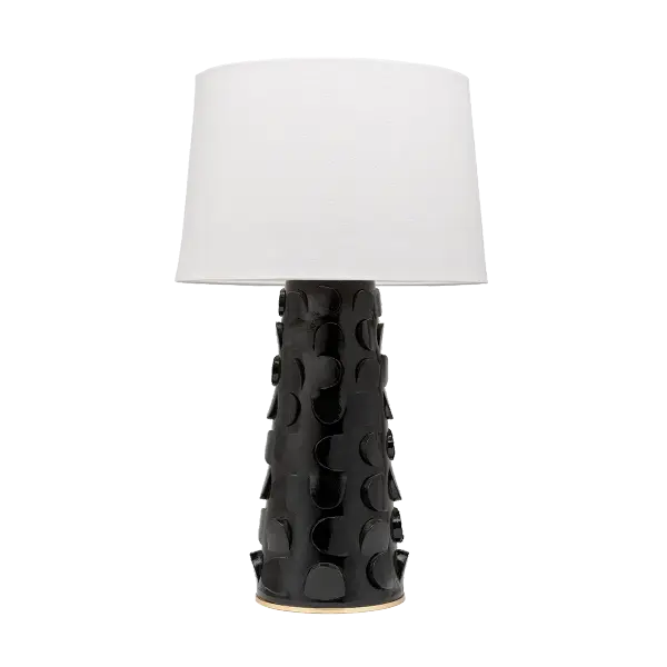 The Naomi table lamp combines whimsical artistry with sophisticated style. Its ceramic base features an eye-catching cut-out motif that adds unexpected texture and dimensionality, while the Gold Leaf accent provides elegant shine.