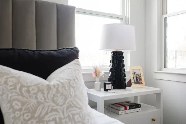 The Naomi table lamp combines whimsical artistry with sophisticated style. Its ceramic base features an eye-catching cut-out motif that adds unexpected texture and dimensionality, while the Gold Leaf accent provides elegant shine. - alternate view