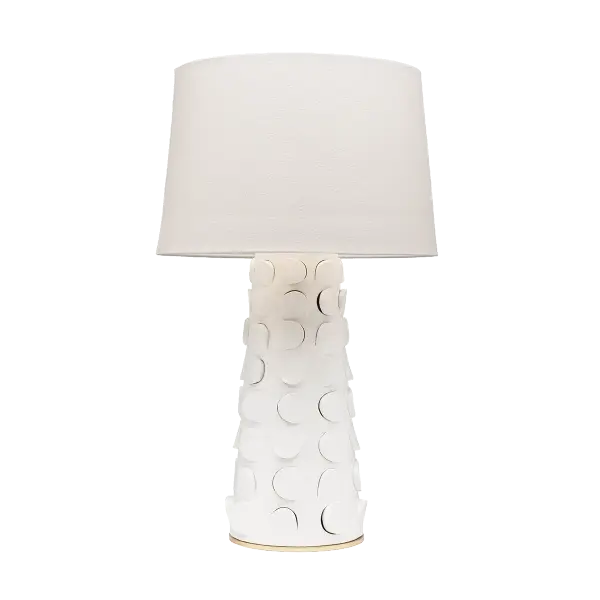 The playful Naomi table lamp is sitting pretty. Embellished with a cut-out motif, the whimsical ceramic base possesses an unexpected dimensionality that adds texture to a space. In either white or black, this lamp makes an artistic and approachable accompaniment to a table or console. A classic linen drum shade adds an air of lightness while the Gold Leaf base lends Naomi a touch of shine.