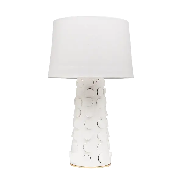 The playful Naomi table lamp is sitting pretty. Embellished with a cut-out motif, the whimsical ceramic base possesses an unexpected dimensionality that adds texture to a space. In either white or black, this lamp makes an artistic and approachable accompaniment to a table or console. A classic linen drum shade adds an air of lightness while the Gold Leaf base lends Naomi a touch of shine. - alternate view