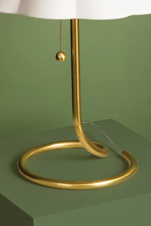 The Martha Table Lamp combines artistic form with practical function. Its twisted aged brass base creates visual interest while maintaining a compact footprint, making it perfect for smaller spaces that need personality. - alternate view