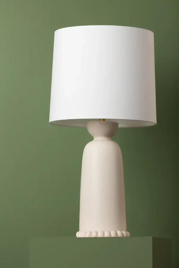 The Rhea Table Lamp brings refreshing retro charm with its antique ivory ceramic base and scalloped sphere accents. The aged brass details and white linen shade create a sophisticated yet approachable design perfect for traditional and transitional spaces. - alternate view