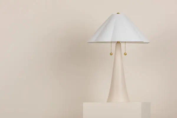 The Alana table lamp combines feminine elegance with functional design. Its white linen scalloped shade and aged brass details create a light, airy aesthetic perfect for traditional and coastal-inspired spaces. - alternate view