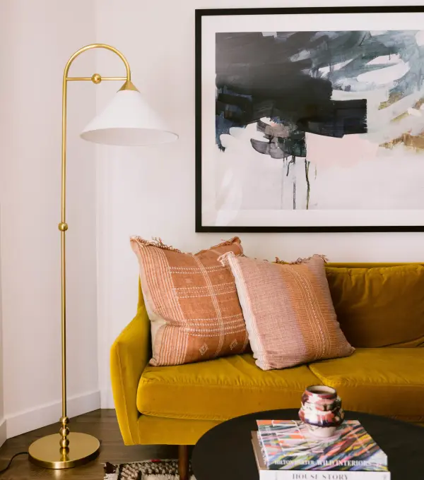 The Sang Floor Lamp brings jewelry-inspired elegance to any space with its geometric silhouette adorned with decorative spheres. Finished in warm Aged Brass with a white linen shade, this designer collaboration piece adds sculptural interest.