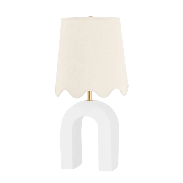 The Roshani Table Lamp combines artistic ceramic design with classic aged brass accents and a scalloped linen shade. Its unique magnet-inspired form creates visual interest while maintaining versatility across traditional and contemporary interiors.