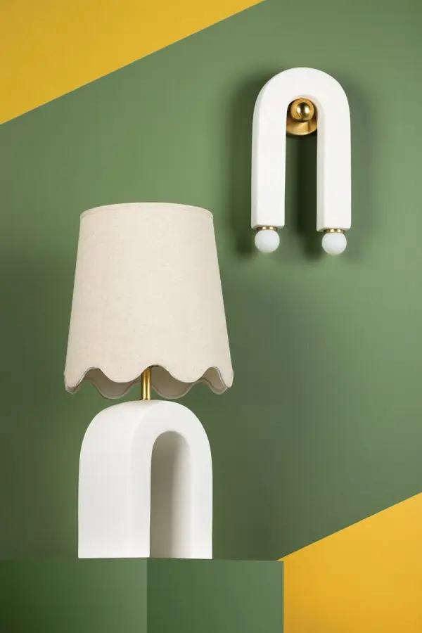 The Roshani Table Lamp combines artistic ceramic design with classic aged brass accents and a scalloped linen shade. Its unique magnet-inspired form creates visual interest while maintaining versatility across traditional and contemporary interiors. - alternate view