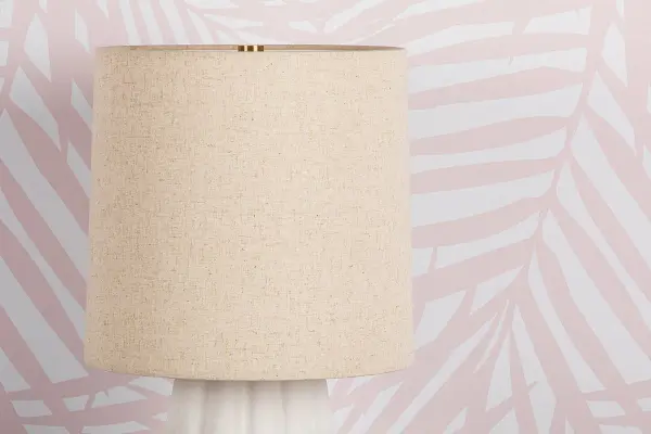 The Maisie Table Lamp brings fashionable coastal charm with its textured white ceramic ruffles and aged brass accents. Perfect for creating beautiful dresser vignettes or adding feminine flair to bathroom vanities. - alternate view
