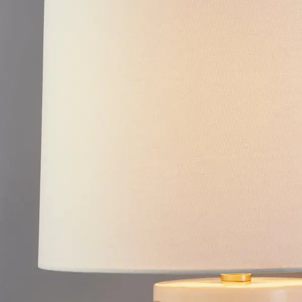 The Minnie Table Lamp brings playful sophistication with its glossy ceramic base featuring geometric patterning and aged brass accents. Part of the Megan Molten x Mitzi collaboration, it adds artisanal charm to any space. - alternate view
