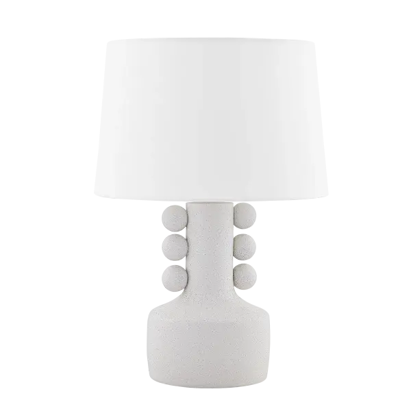 The Amalia Table Lamp brings surrealist charm to modern interiors with its vessel-like silhouette and distinctive speckled crackle glaze. Decorative sphere accents and a crisp white linen shade create a sophisticated monochromatic statement piece.