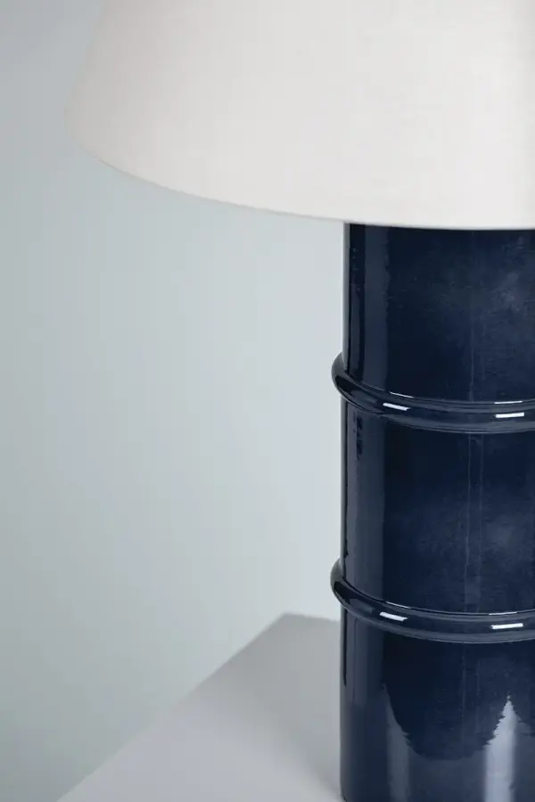 Natural appeal abounds with this abstracted bamboo design that is reminiscent of Henry Link Bali Hai furniture. Add organic style to the wall or ceiling with the sconce or chandelier, both available in a black or white finish to flow with any color scheme. The lamp's dark navy ceramic base adds color and drama to tabletops without overpowering the space. Part of our Ariel Okin x Mitzi Tastemakers collection. Collection: Banyan Designer: Ariel Okin Finish: Aged Brass Glass: White Width: 16.00" Height: 25.50" Length: 16.93" Weight: 10.80 lb Canopy: 4.75" Number of Bulbs: 1 Maximum Wattage: 15.00 W Bulb Type: A19 Bulb Base: E26 Medium Voltage: 120.00 V Material: Steel Country of Origin: VN Safety Listing: UL Safety Rating: Dry Switch: On/Off Switch On Socket Manufacturer Warranty: 1 Year Limited Manufacturer Spec Sheet Instructions - alternate view
