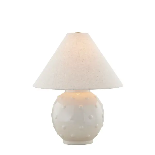 The Annabelle table lamp combines whimsical polka dot texture with sophisticated ivory ceramic and natural linen. Part of the Ariel Okin collaboration, it balances fun design elements with versatile neutral tones. - alternate view