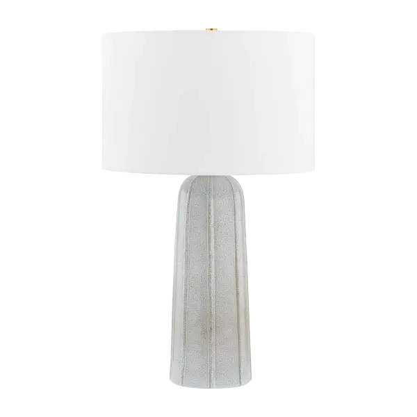 The Kel Table Lamp beautifully balances rustic texture with refined sophistication. Its reactive ash ceramic base features an organic, sandstorm-like pattern that brings natural character to any space, while the crisp white linen shade and aged brass neck add elegant contrast.