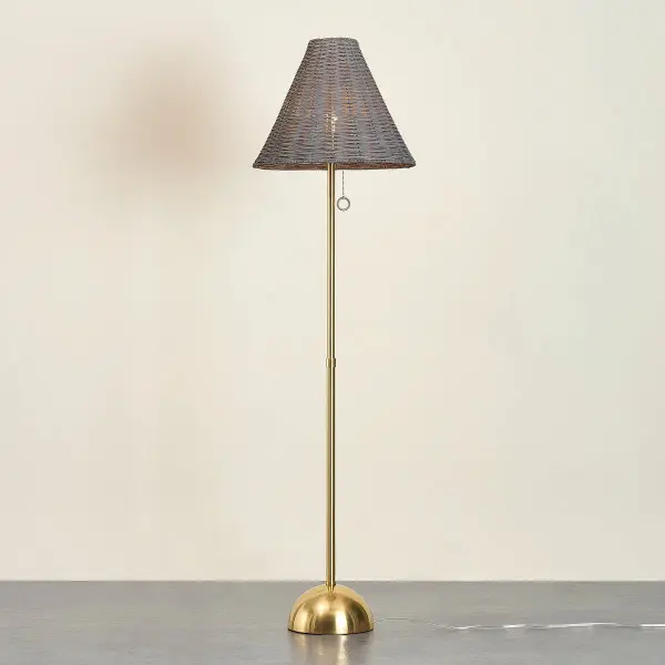 The Destiny Floor Lamp beautifully combines natural gray wicker with polished Aged Brass, creating a warm, earthy glow perfect for coastal and organic modern interiors. Its handcrafted nature ensures each piece is unique. - alternate view