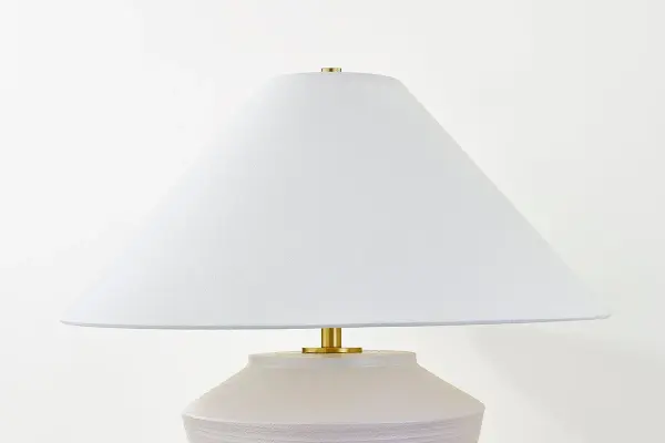 The Rachie Table Lamp brings calm, organic beauty to any space with its whitewashed terracotta body and aged brass accents. The angular white linen shade provides clean contrast to the textural base, creating a sophisticated blend of natural and refined elements. - alternate view