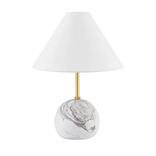 The Jewel Table Lamp combines honed Calcutta gold marble with aged brass in a sophisticated geometric design. Its petite stature and luxurious materials make it perfect for adding refined style to intimate spaces.