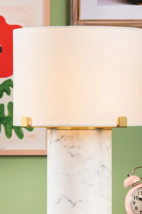 The Rumi Table Lamp combines natural Carrara marble with Aged Brass accents for an elevated, petite design. Each piece features unique veining patterns, making it a one-of-a-kind statement for bedside or desk applications. - alternate view