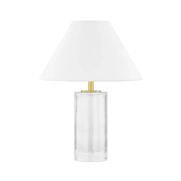 The Mandy Table Lamp combines artisanal blown glass with tailored design, featuring a clear glass base, white linen shade, and aged brass details. Its compact size and versatile aesthetic work beautifully in multiple settings.