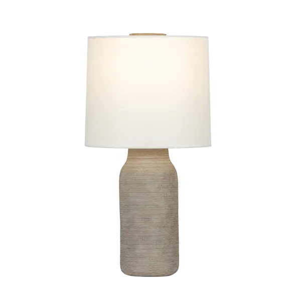 The Stassi table lamp brings warmth and texture to modern interiors with its artisanal ceramic base in grey-brown matte glaze. Horizontal etched linework and an oversized ceramic finial add sculptural interest, while the white linen drum shade provides soft, balanced illumination.