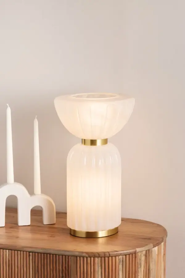The Cordelia Table Lamp blends updated neoclassical design with contemporary flair. Its fluted column base and cloud glass create an enchanting all-over glow, while Aged Brass cuffs add vintage sophistication. - alternate view