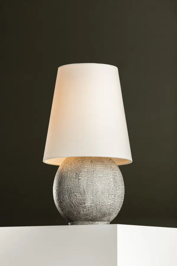 The Ulsterville combines artifact-like ceramic craftsmanship with modern rechargeable LED technology. Its oversized linen shade and textured spherical base create a striking focal point despite its petite size, perfect for versatile styling. - alternate view