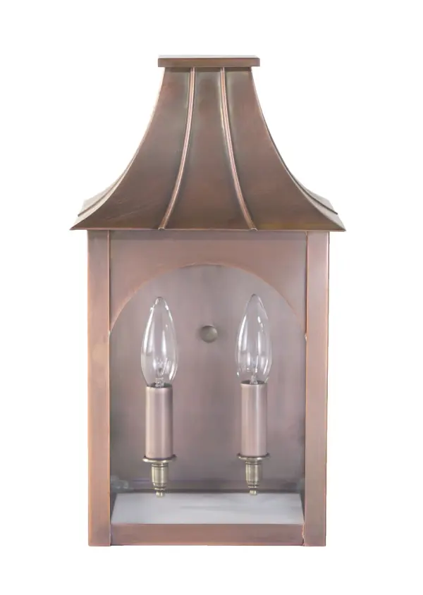 The Kensington collection reflects the character of its namesake town: quiet, crafted, and rooted in natural simplicity. Hand-formed in brass or copper, its flared roofline and clear glass chimney give the feel of a traditional lantern while delivering refined, durable construction. This piece brings the warmth of artisan workmanship to any exterior, with a silhouette inspired by the forests and small-town heritage of Kensington, NH. Kensington Small Wall Light Dimensions: 8"W x 8.25"D x 14.5"H Mounting height (From top to mounting bracket): 9" Bulb type: One 60-Watt Candelabra Suitable location: Wet Mounting Area: 6"W x 8.25"H Contact Dealer for Pricing & Availability Download Spec Sheet Note: Some photos are a digital rendering to show our finish, glass and socket options our actual finishes are hand-applied and our glass is hand-blown and will have natural variations from the photos. - alternate view
