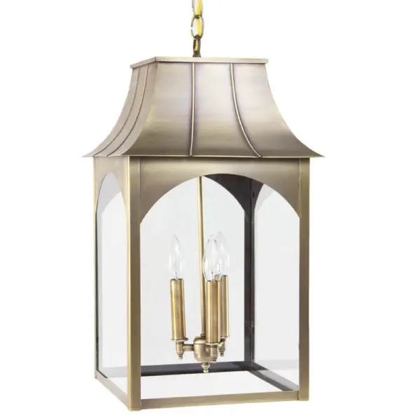 The Kensington collection reflects the character of its namesake town: quiet, crafted, and rooted in natural simplicity. Hand-formed in brass or copper, its flared roofline and clear glass chimney give the feel of a traditional lantern while delivering refined, durable construction. This piece brings the warmth of artisan workmanship to any exterior, with a silhouette inspired by the forests and small-town heritage of Kensington, NH. Kensington Hanging Light Dimensions: 12"W x 12"D x 22"H Mounting height (From top to mounting bracket): 36" Chain Bulb type: Three 60-Watt Candelabra Suitable location: Damp Mounting Area: 5" Diam. Contact Dealer for Pricing & Availability Download Spec Sheet Note: Some photos are a digital rendering to show our finish, glass and socket options our actual finishes are hand-applied and our glass is hand-blown and will have natural variations from the photos. - alternate view