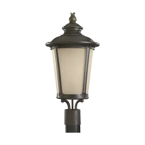 The Cape May post lantern brings traditional coastal charm to outdoor spaces with its burled iron finish and etched hammered glass. The light amber glass creates a warm, inviting ambiance perfect for pathways and entryways.