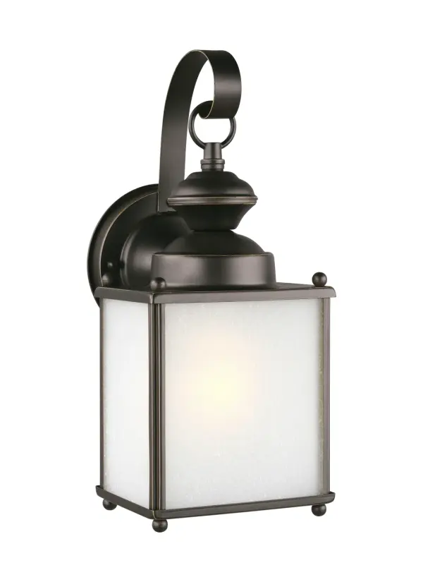 The Jamestowne wall lantern combines classic styling with modern LED technology in a compact 12.5-inch design. Its antique bronze finish and frosted seeded glass create warm, welcoming illumination for entryways and outdoor spaces.
