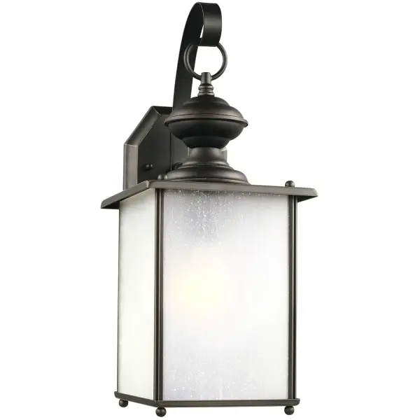 The Jamestowne wall lantern combines traditional styling with practical outdoor performance. Its antique bronze finish and frosted seeded glass create warm, welcoming illumination for entryways and porches.