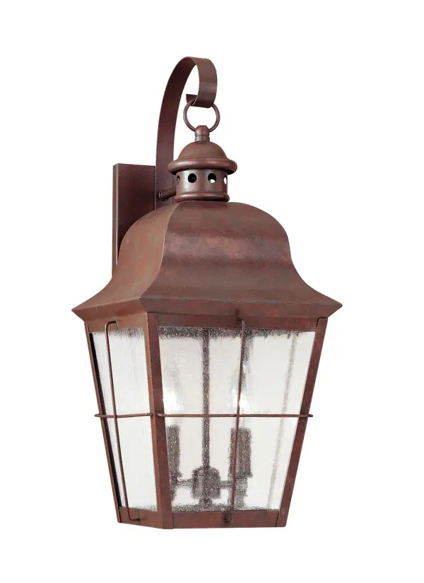 The Chatham wall lantern brings traditional charm to outdoor spaces with its weathered copper finish and clear seeded glass. Compact at 9.25" wide, it's ideal for flanking doors or illuminating smaller exterior areas with warm LED light.