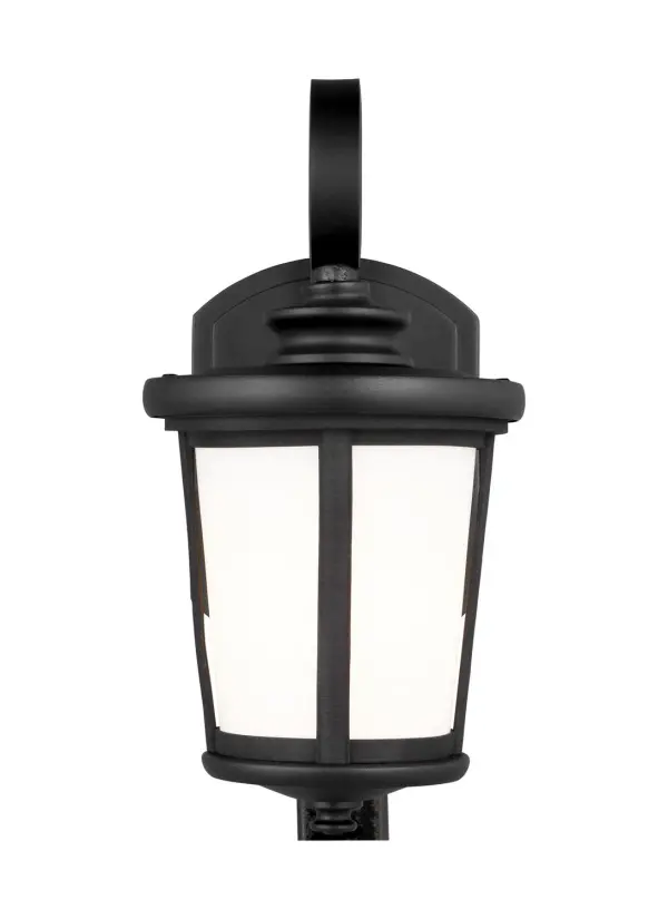 The Eddington outdoor wall lantern combines clean transitional styling with practical wet-rated performance. Its compact 6-inch width and cased opal glass provide soft, diffused illumination ideal for entryways and porches.