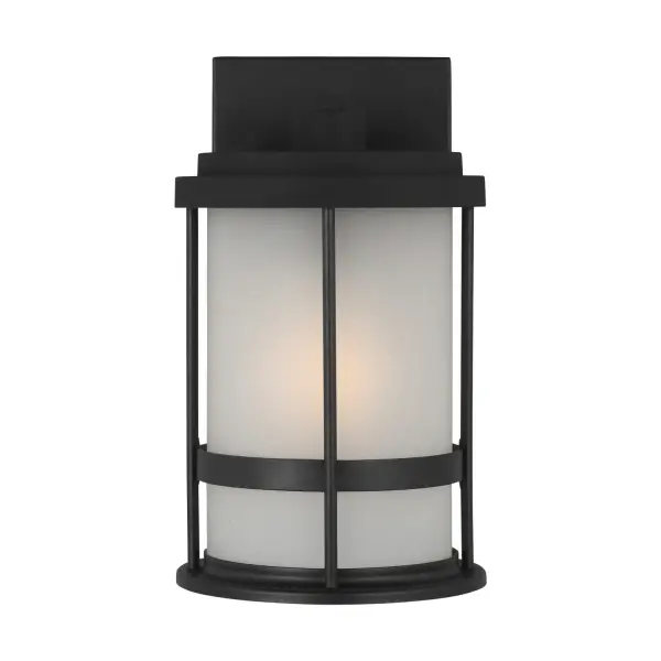 The Wilburn wall lantern delivers reliable outdoor lighting in a compact 6-inch profile. Its wet-rated aluminum construction and satin etched glass make it ideal for exposed locations while maintaining a clean, transitional aesthetic.