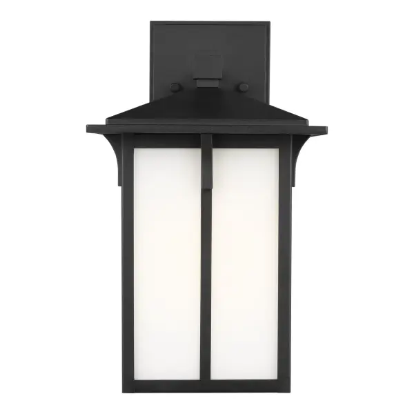 The Tomek outdoor wall lantern combines transitional styling with practical durability. Its compact 14-inch height and etched white glass create soft, welcoming illumination for entryways and outdoor living spaces.